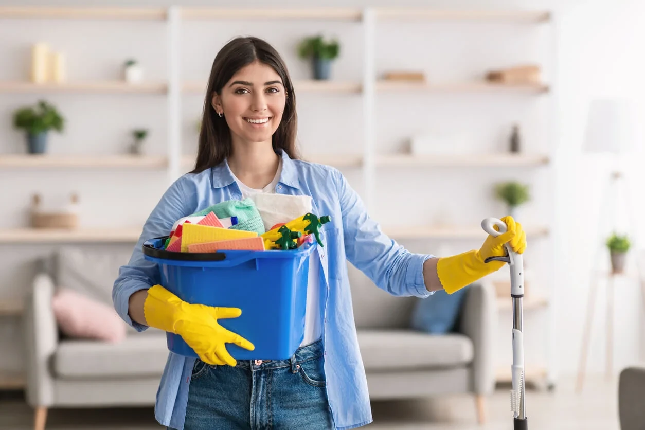 Luxury house cleaning in Vancouver: smiling maid with mop and supply bucket